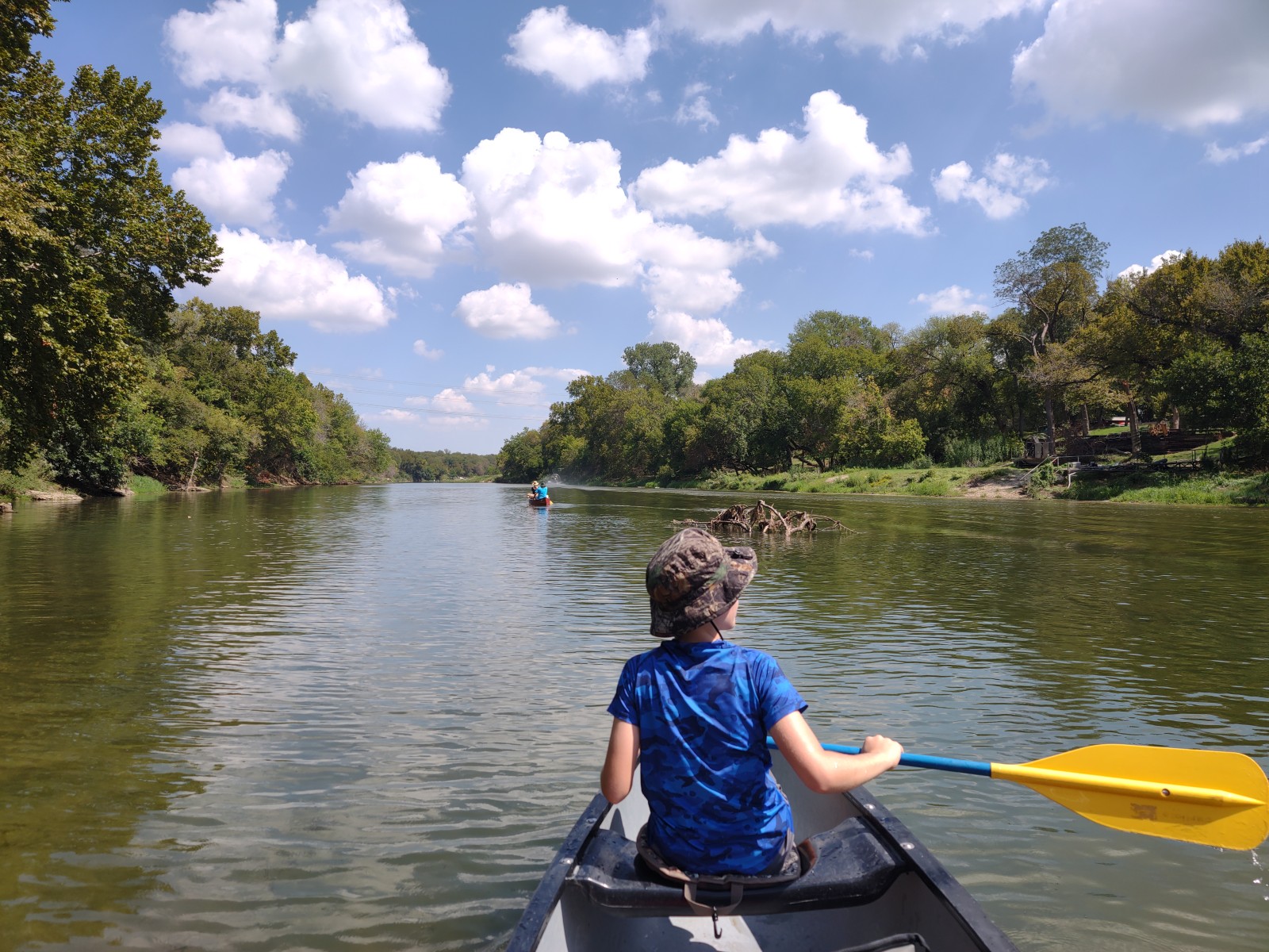Kayakers gathered near the riverbank